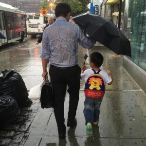 爸爸全身湿透为儿子撑伞感动百万网友